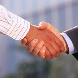 Two people shaking hands after a business agreement