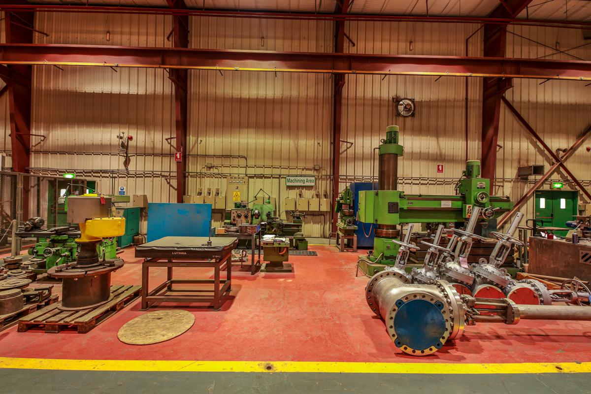 The machine shop, with lathes and drilling machines and a large flanged spool to one side