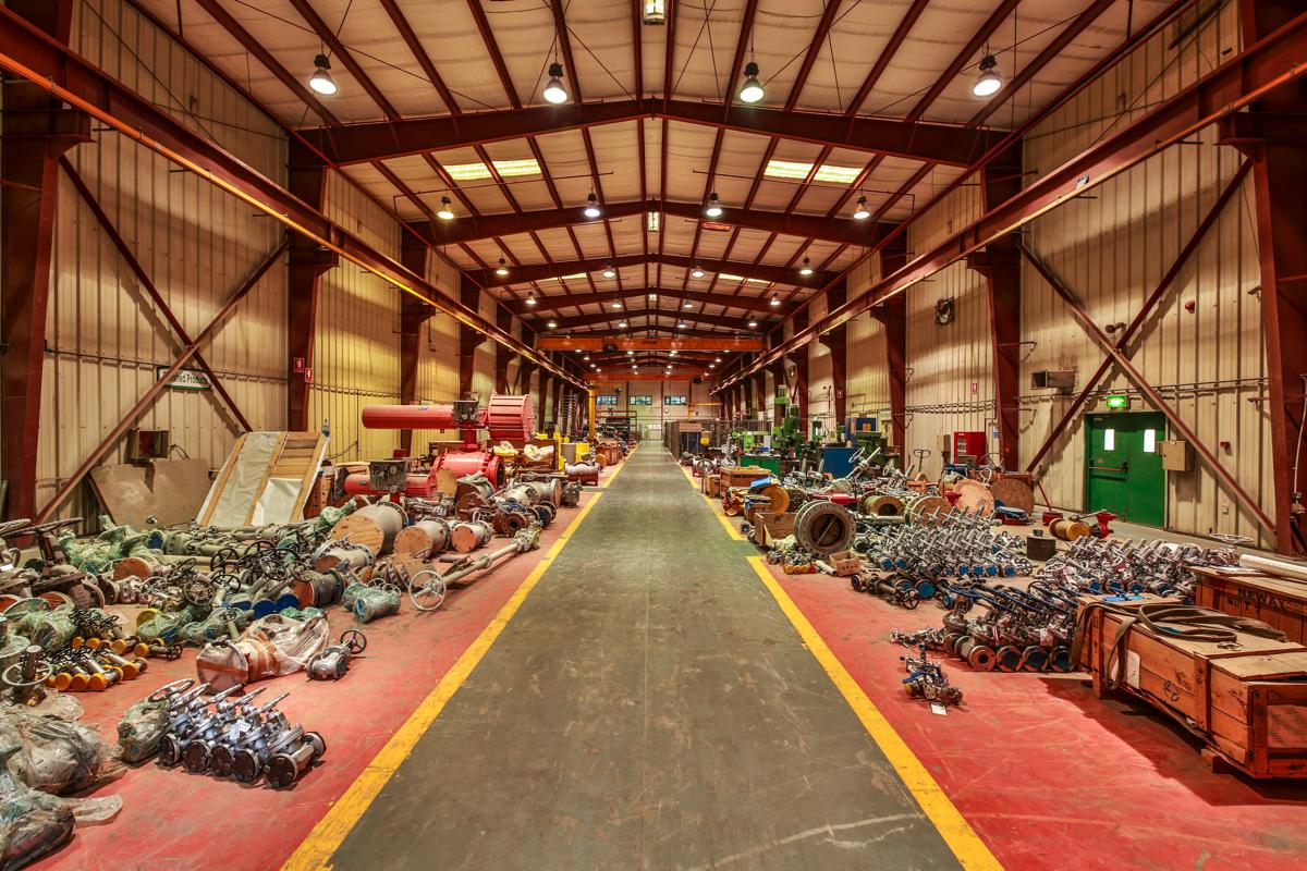 The main workshop bay seen down its full length, valves ranged along both sides