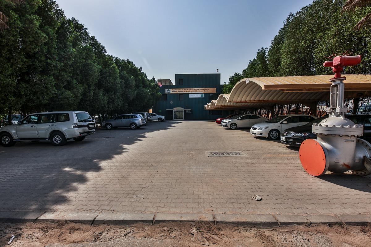 The car park in front of the WIASC building, a gate valve with painted flange covers in the foreground
