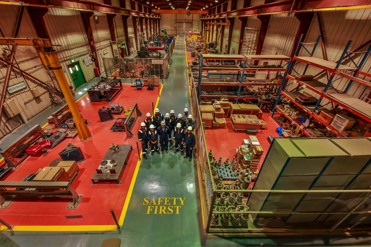The workshop team standing together on the central walkway, photographed from above