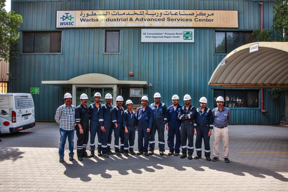 The team lined up outside the building beneath the WIASC sign