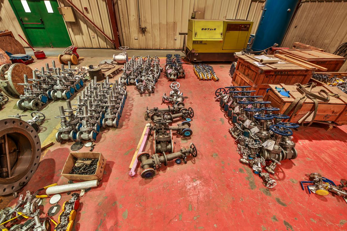 Gate valves laid out on the workshop floor awaiting service