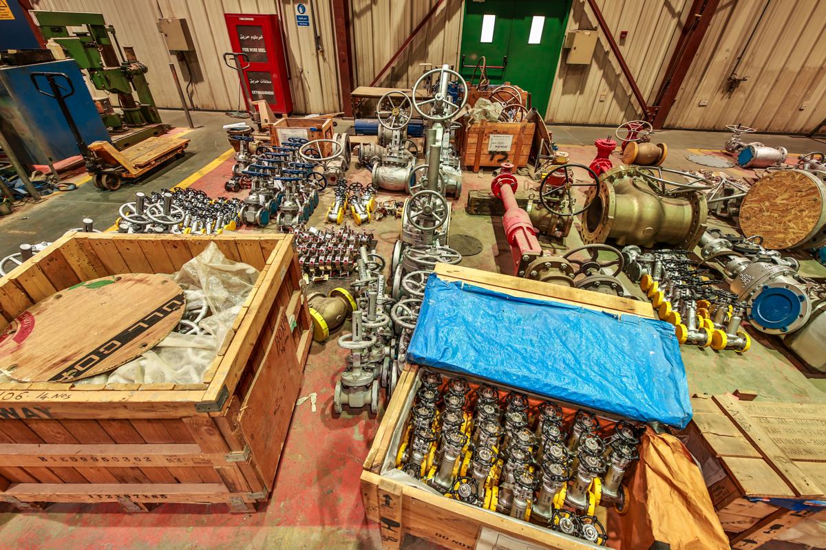 Valves gathered by the fire hose reel, with an open crate of tagged valves in front