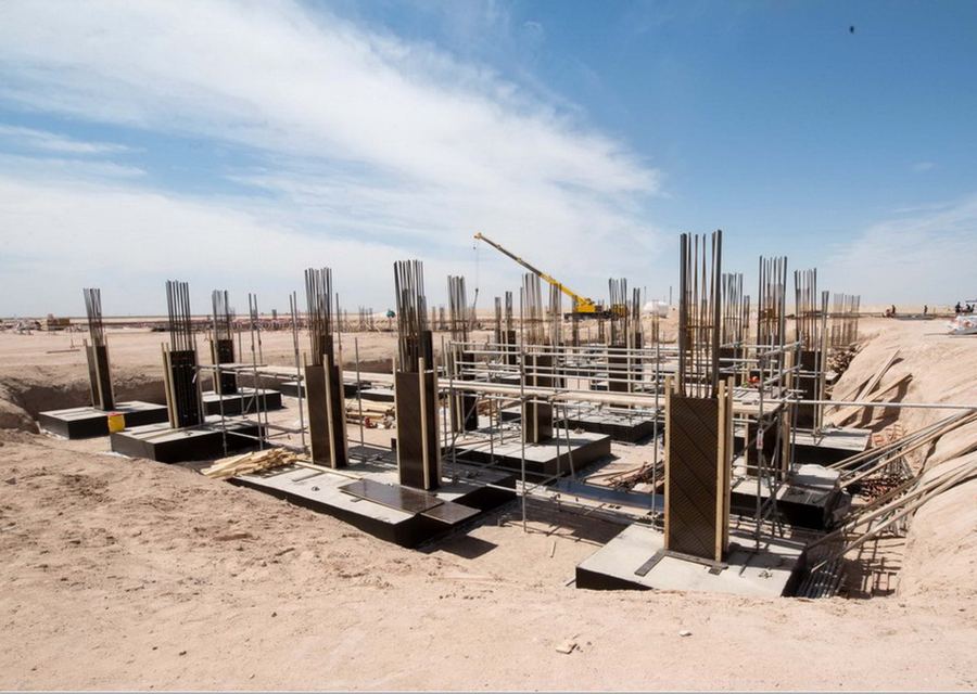 Civil works: reinforced concrete column bases and rebar cages on a desert site